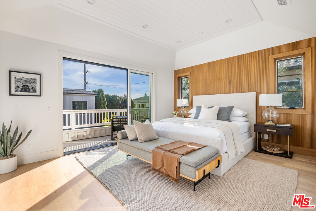 628 10th Street Santa Monica, CA 90402 - Photo 18 of 48 a bedroom with a bed lamp and a large window with outer view