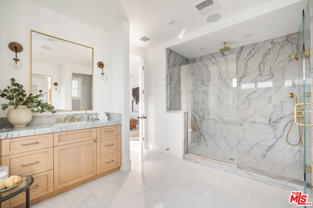 628 10th Street Santa Monica, CA 90402 - Photo 21 of 48 a bathroom with a double vanity sink toilet and shower