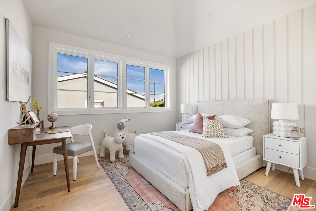 628 10th Street Santa Monica, CA 90402 - Photo 22 of 48 a bedroom with a bed and a table in it