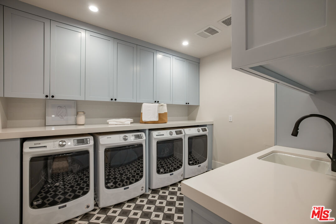 628 10th Street Santa Monica, CA 90402 - Photo 32 of 48 a kitchen with a stove a sink and a microwave