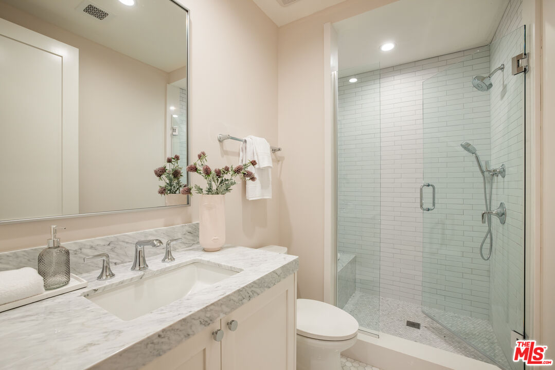 628 10th Street Santa Monica, CA 90402 - Photo 34 of 48 a bathroom with a granite countertop sink a toilet and shower