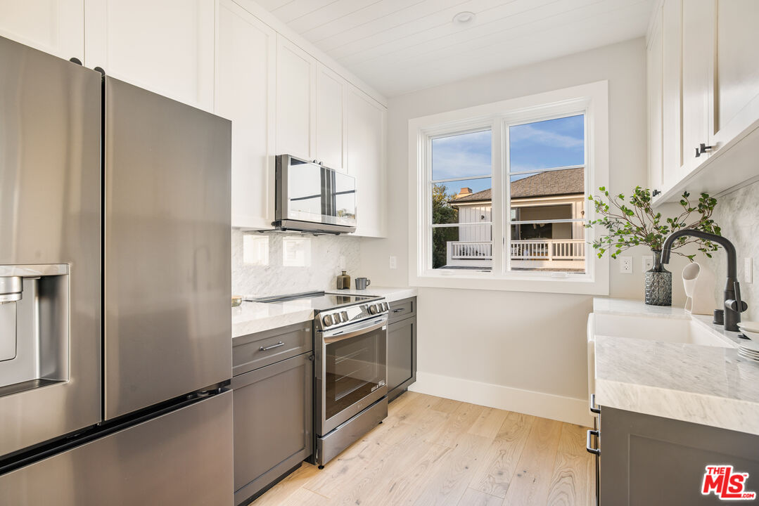 628 10th Street Santa Monica, CA 90402 - Photo 39 of 48 a kitchen with stainless steel appliances granite countertop a refrigerator and a sink