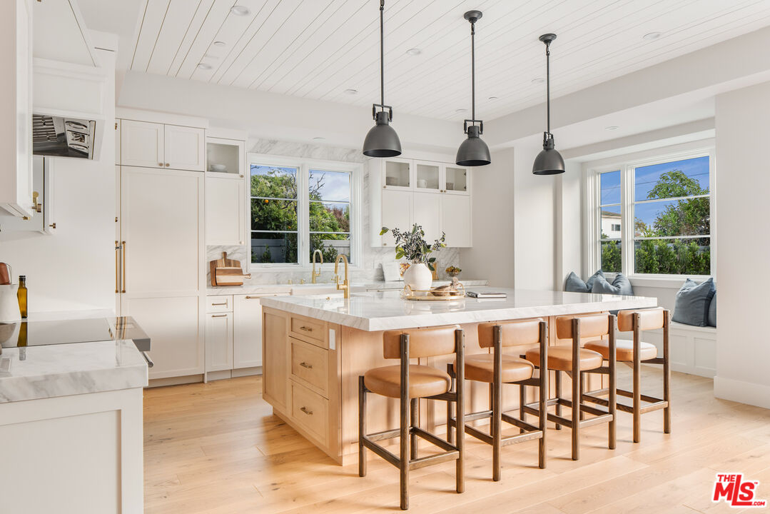 628 10th Street Santa Monica, CA 90402 - Photo 9 of 48 a dining table chairs and a chandelier