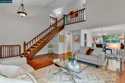 a living room with furniture or stairs and a wooden floor
