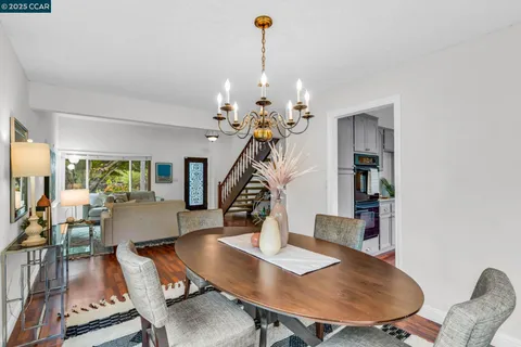 a view of a dining room with furniture wooden floor and chandelier