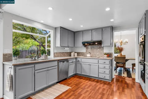 a kitchen with sink cabinets and wooden floor