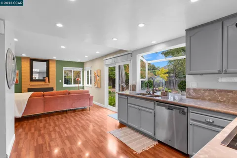 a large kitchen with kitchen island granite countertop a large window in it