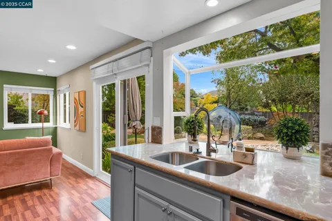a kitchen with sink and large window