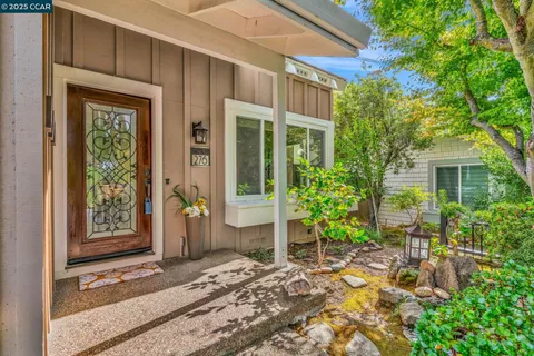 a view of a entryway door of the house with outdoor seating