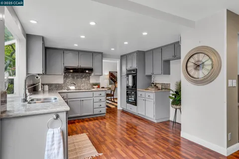 a kitchen with a refrigerator cabinets and a sink