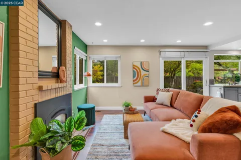 a living room with furniture and a potted plant