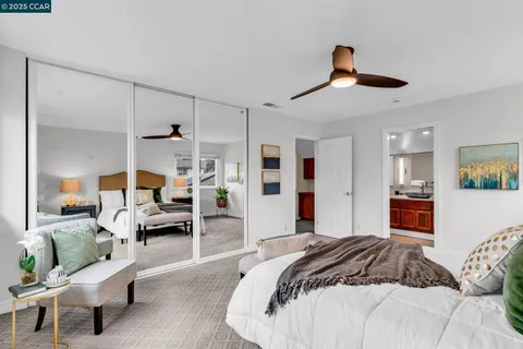 a bedroom with a bed couch and window