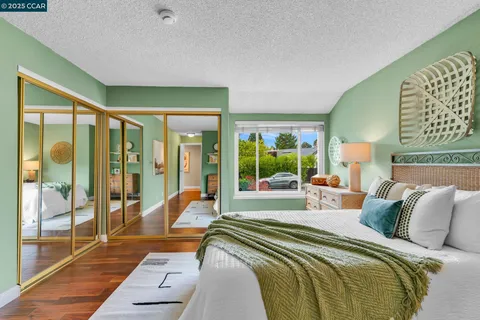 a bed sitting in a bedroom next to a window