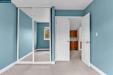a view of a hallway with an entryway door