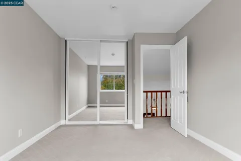 a view of an empty room with a fireplace