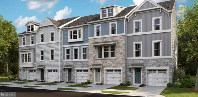 a front view of a residential apartment building with yard