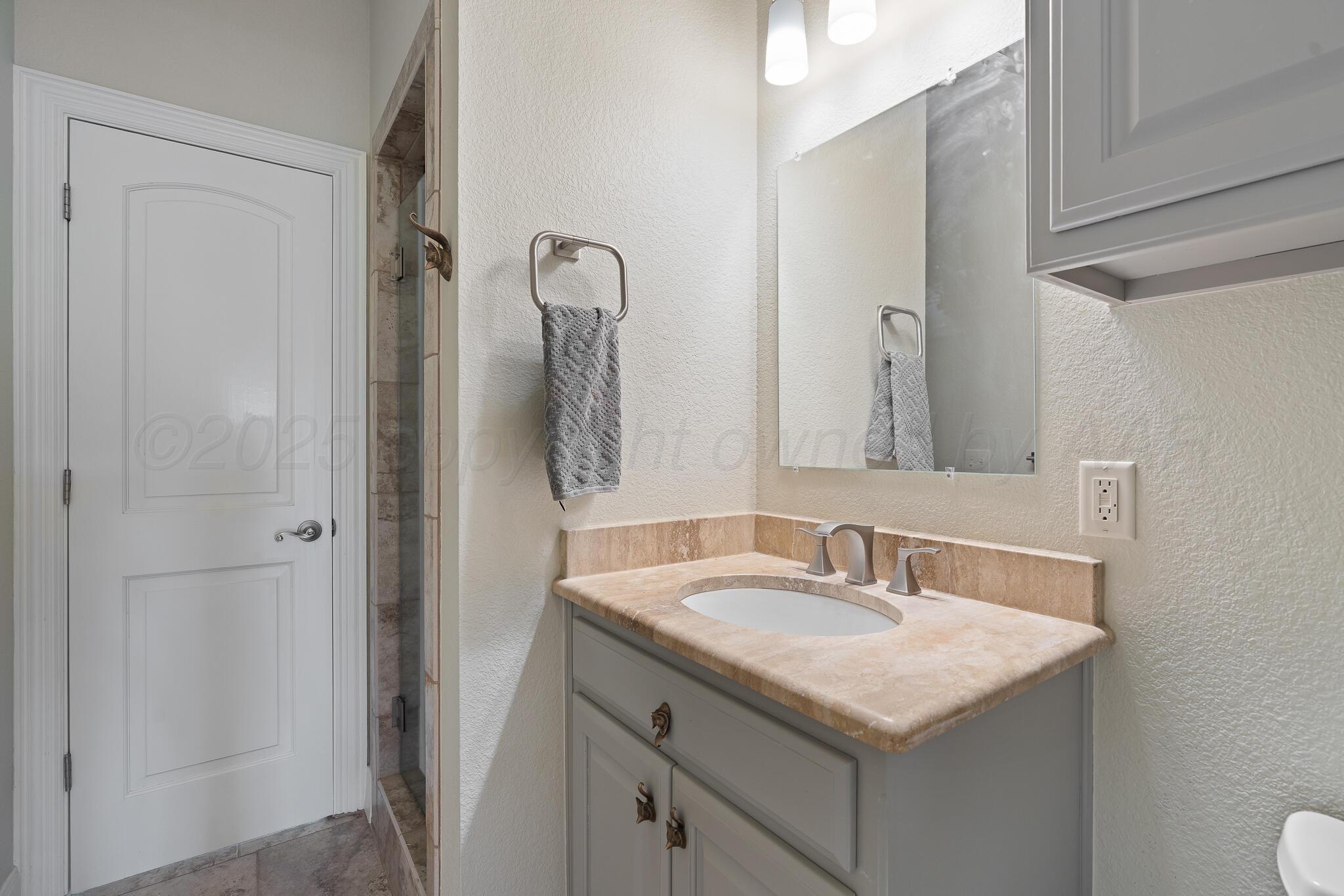 17301 Spring Lake Drive Canyon, TX 79015 - Photo 12 of 62 a bathroom with a sink and a mirror