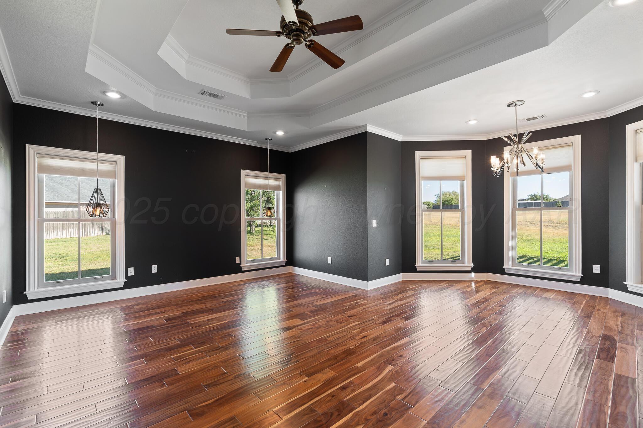 17301 Spring Lake Drive Canyon, TX 79015 - Photo 13 of 62 a view of an empty room with window and wooden floor