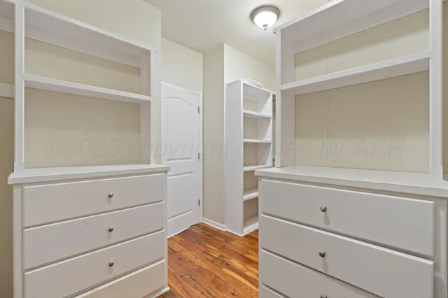a kitchen with kitchen island granite countertop a sink cabinets and stainless steel appliances