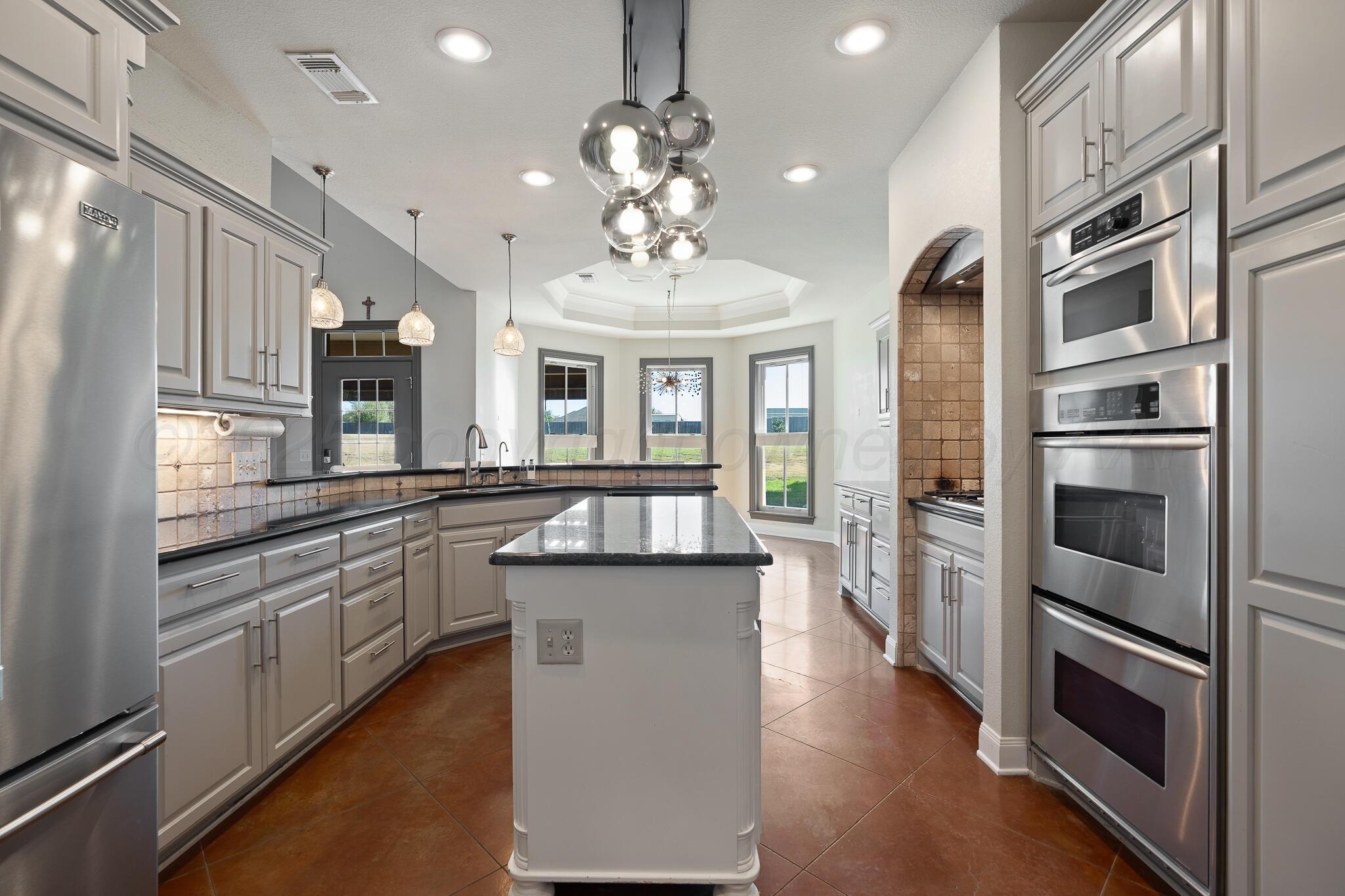 17301 Spring Lake Drive Canyon, TX 79015 - Photo 19 of 62 a kitchen with stainless steel appliances granite countertop a refrigerator and a sink