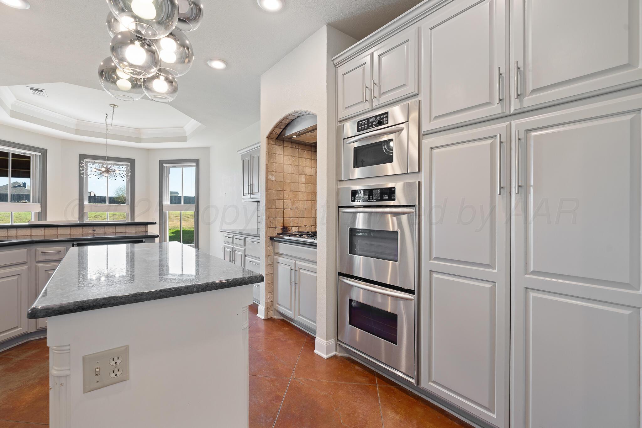 17301 Spring Lake Drive Canyon, TX 79015 - Photo 20 of 62 a kitchen with stainless steel appliances granite countertop a refrigerator and a sink