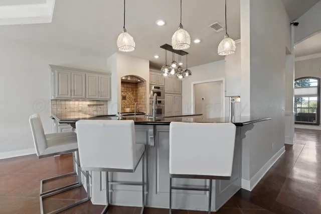 a bathroom with a granite countertop sink a mirror and shower curtain