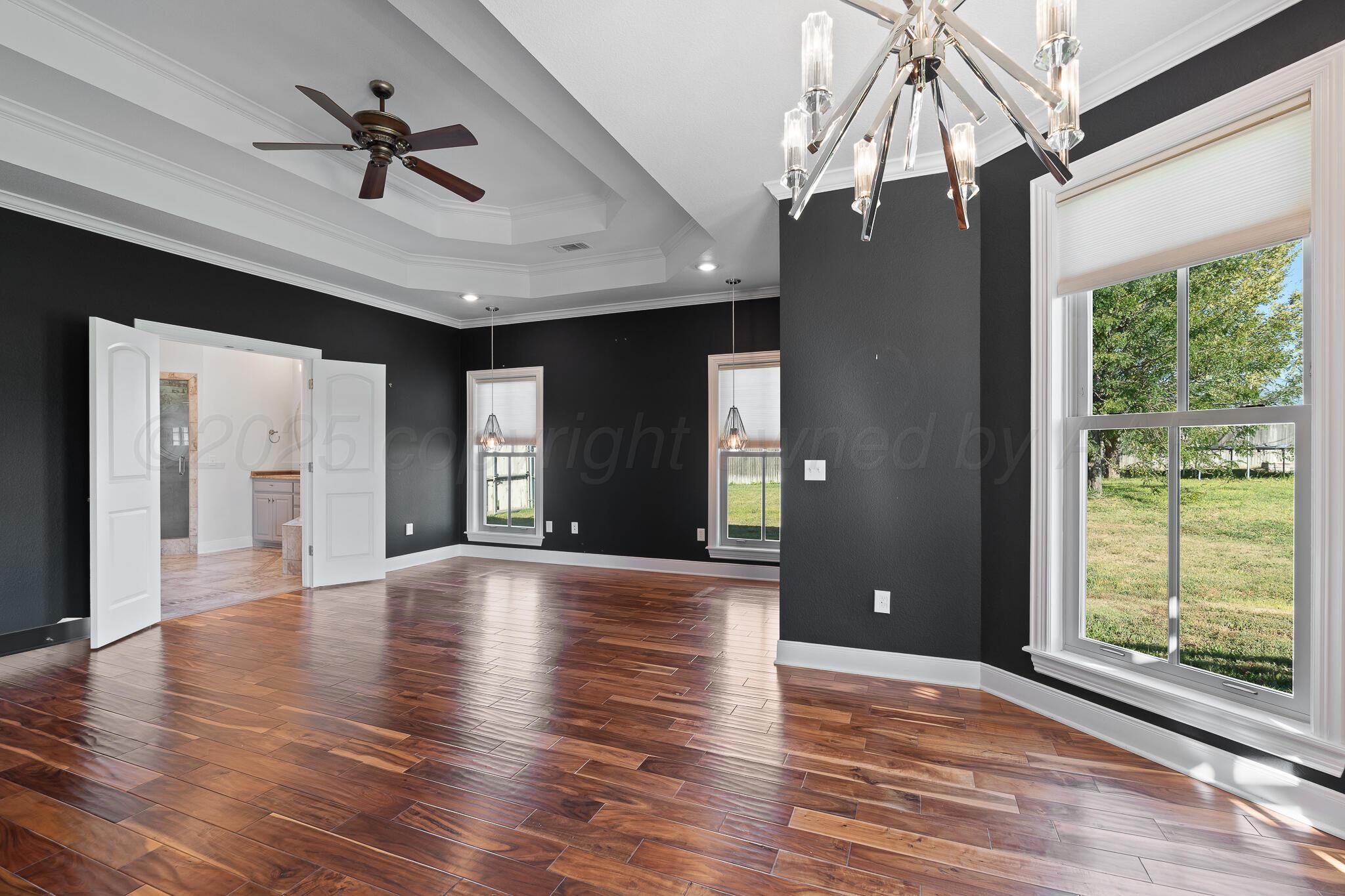 17301 Spring Lake Drive Canyon, TX 79015 - Photo 3 of 62 a view of an empty room and window with wooden floor