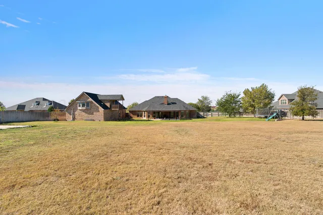 an aerial view of residential house with outdoor space and parking