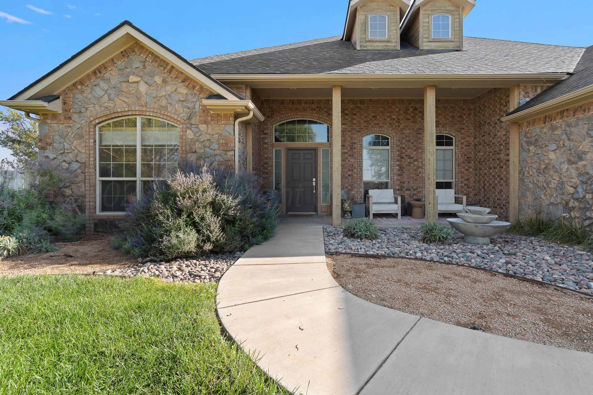 17301 Spring Lake Drive Canyon, TX 79015 - Photo 50 of 62 a view of a house with a small yard plants and large tree