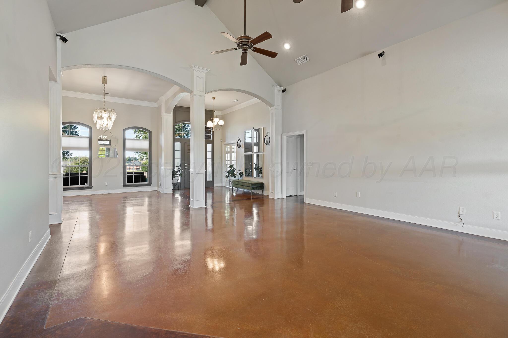 17301 Spring Lake Drive Canyon, TX 79015 - Photo 7 of 62 an empty room with wooden floor and a ceiling fan