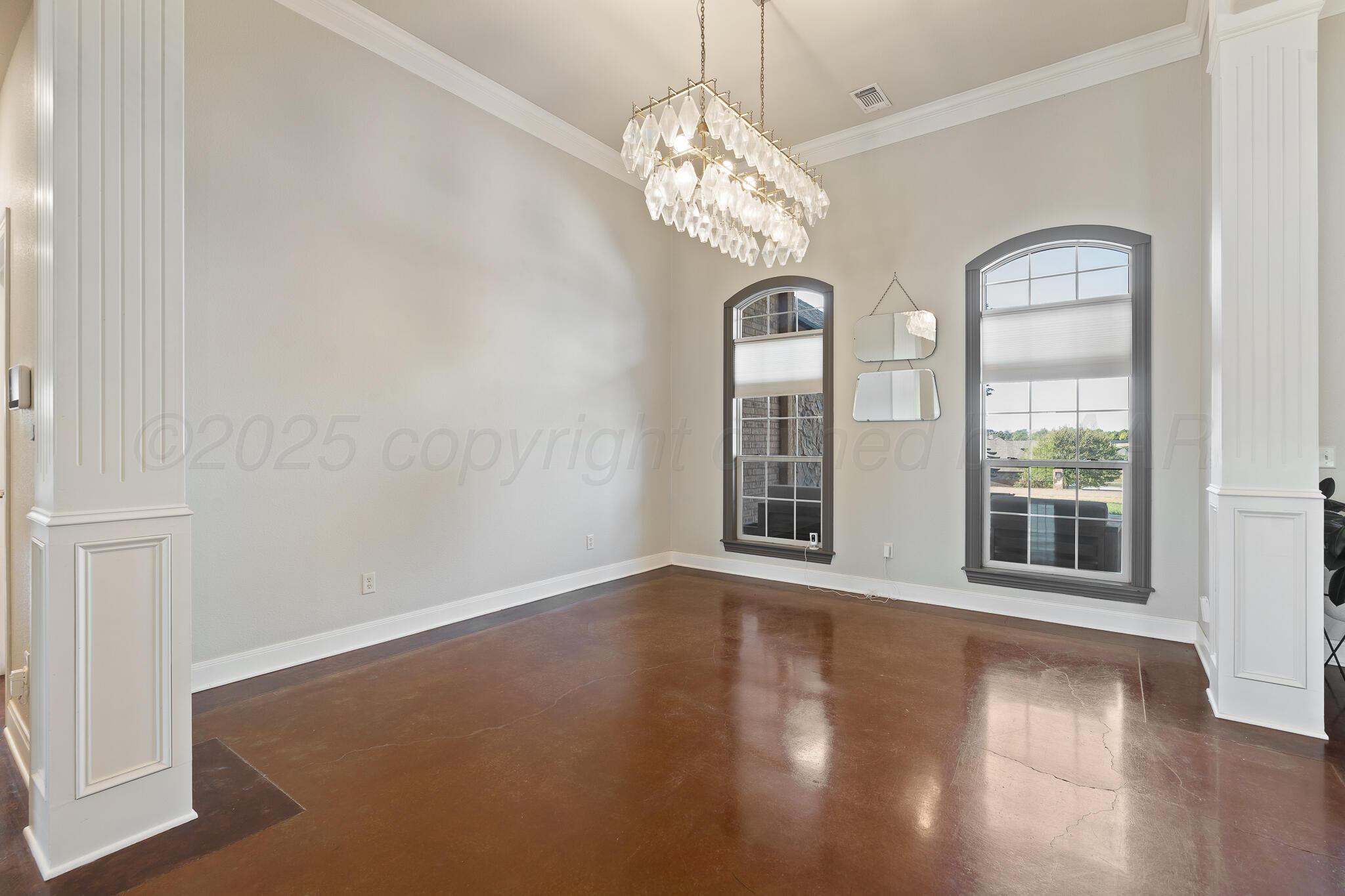 17301 Spring Lake Drive Canyon, TX 79015 - Photo 9 of 62 a view of an empty room with wooden floor and a window