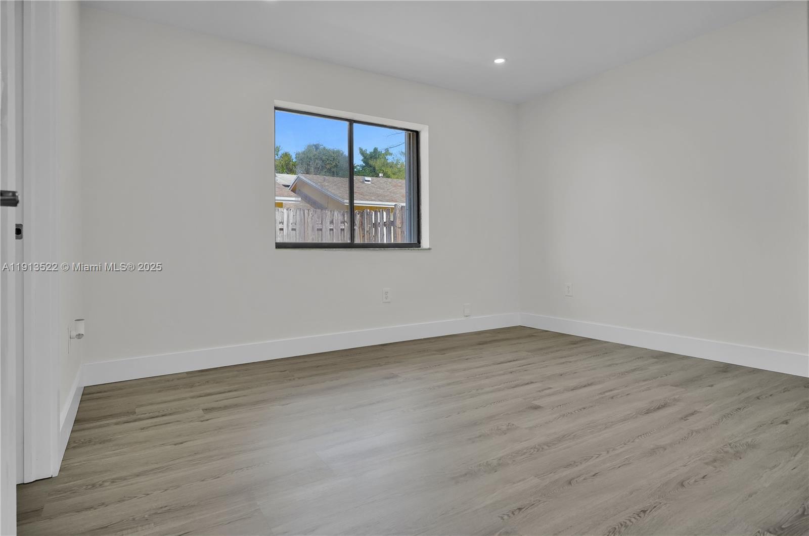 20127 Southwest 88th Court, Unit 20127 Cutler Bay, FL 33189 - Photo 11 of 19 an empty room with wooden floor and window