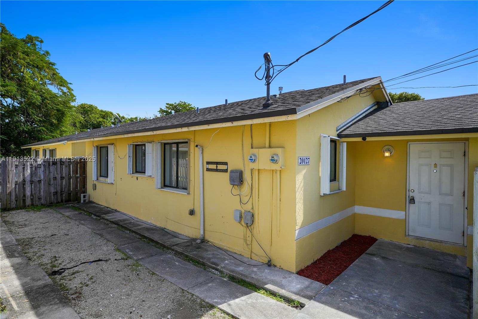 20127 Southwest 88th Court, Unit 20127 Cutler Bay, FL 33189 - Photo 15 of 19 a front view of a house with a wooden fence
