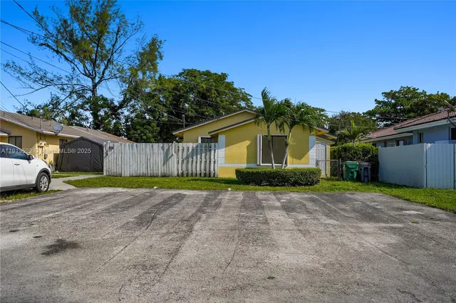 a view of a house with a yard and garage