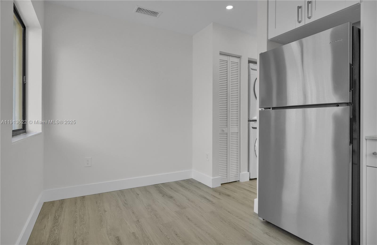 20127 Southwest 88th Court, Unit 20127 Cutler Bay, FL 33189 - Photo 2 of 19 a view of a kitchen with a refrigerator and wooden floor