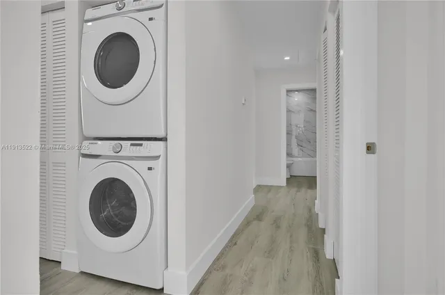 a view of a hallway with washer and dryer