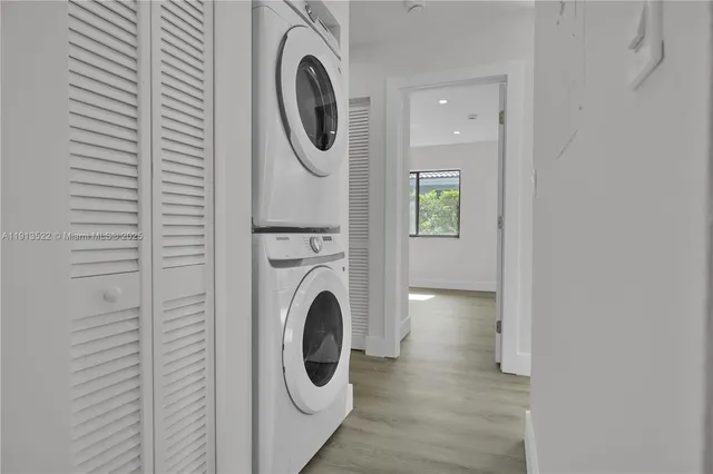 a view of a hallway with washer and dryer