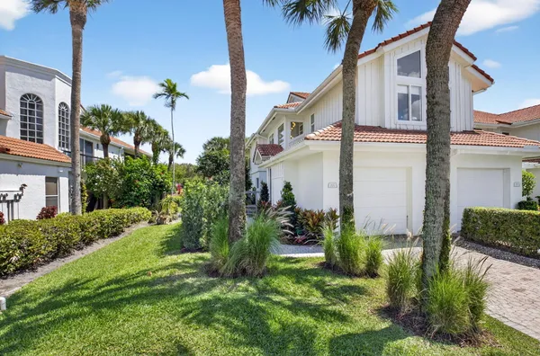 a view of a house with a yard and plants
