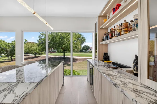 a kitchen with a large window and a sink
