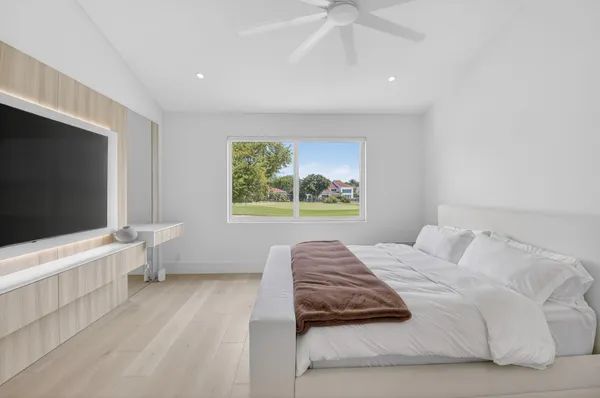 a bedroom with a bed and a flat screen tv