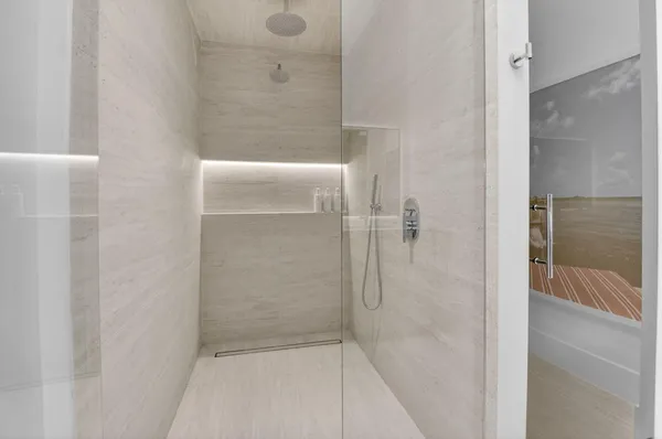 a bathroom with a glass shower door