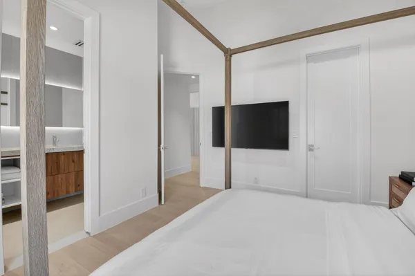 a bedroom with a bed and a flat screen tv