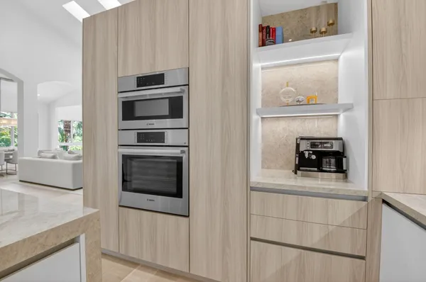 a kitchen with white cabinets and black appliances