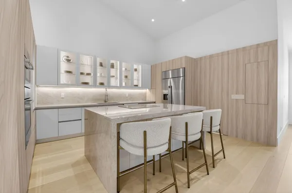 a kitchen with kitchen island a sink table and chairs