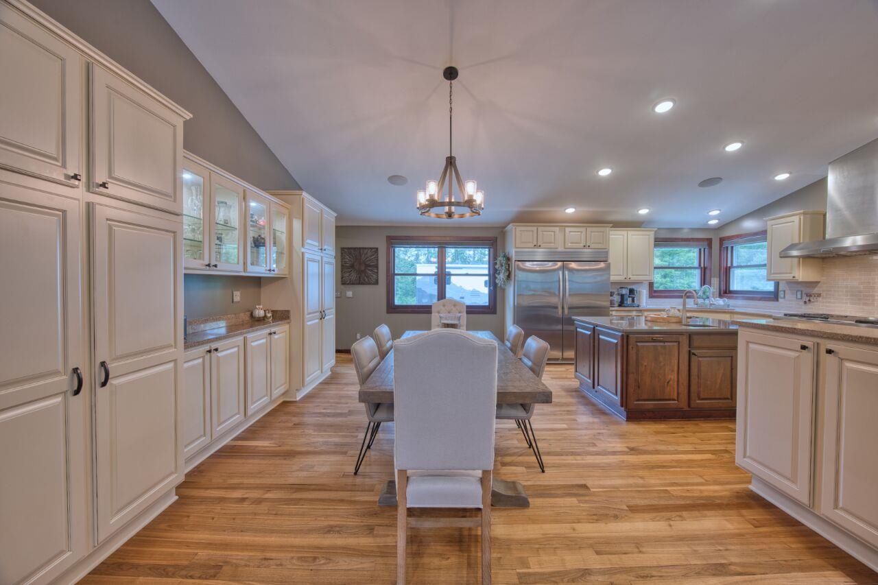 3557 Haverkamp Road Hibbing, MN 55746 - Photo 12 of 60 Dining space with a chandelier, light wood finished floors, lofted ceiling, healthy amount of natural light, and recessed lighting
