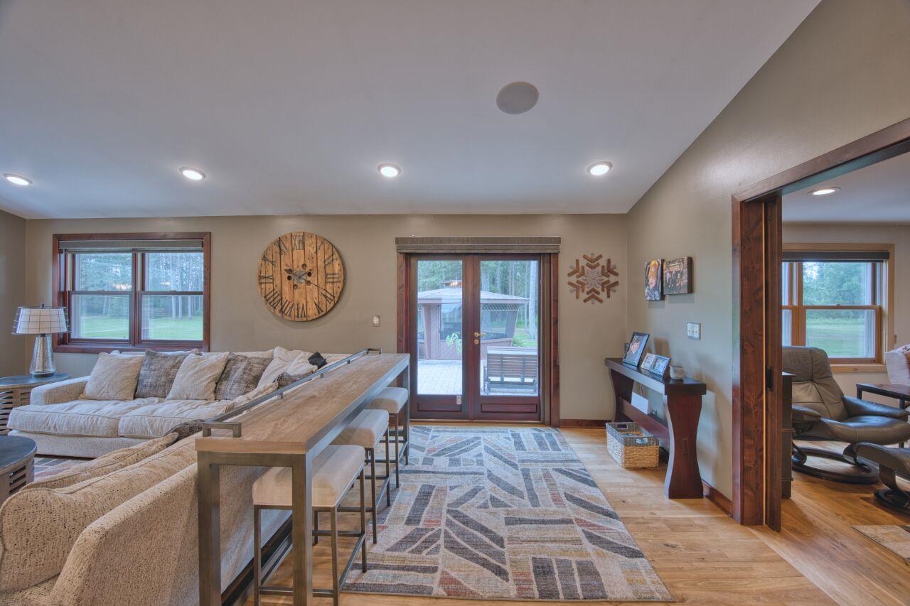 3557 Haverkamp Road Hibbing, MN 55746 - Photo 18 of 60 Living area with plenty of natural light, light wood-type flooring, recessed lighting, french doors, and vaulted ceiling
