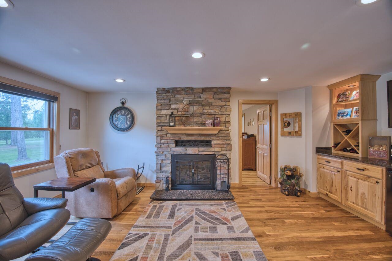 3557 Haverkamp Road Hibbing, MN 55746 - Photo 21 of 60 Living area featuring light wood-type flooring, a fireplace, and recessed lighting