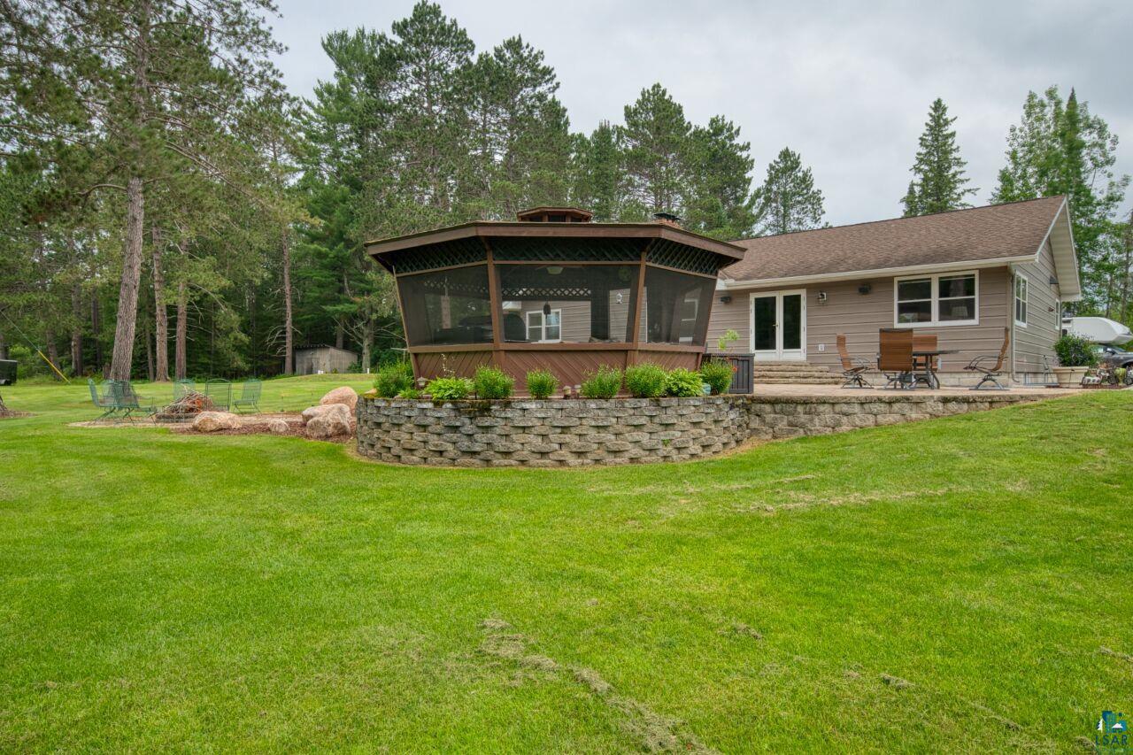 3557 Haverkamp Road Hibbing, MN 55746 - Photo 3 of 60 Back of house with a sunroom, a lawn, and a patio area