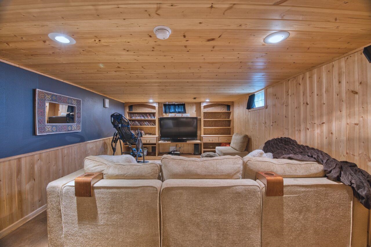 3557 Haverkamp Road Hibbing, MN 55746 - Photo 32 of 60 Carpeted living room with wood walls, built in features, wooden ceiling, wainscoting, and recessed lighting