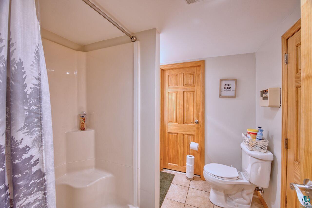 3557 Haverkamp Road Hibbing, MN 55746 - Photo 33 of 60 Bathroom featuring a stall shower and tile patterned floors